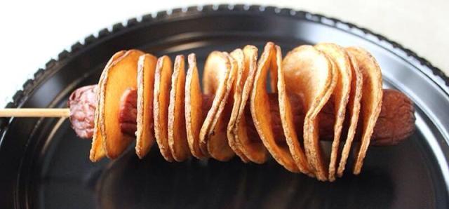 The Auger Dogger, a deep-fried hot dog on a stick wrapped in potato chips, is being added to the food menu at Fifth Third Ballpark this year. (Photo courtesy of the West Michigan Whitecaps)